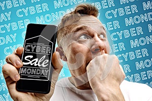 Portrait of man showing screen of mobile phone, black friday