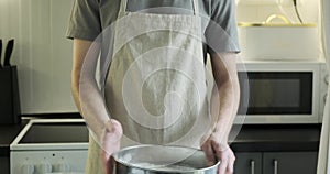 Portrait of a Man Sieving Flour through a Sieve