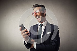 Portrait of a man with a smartphone laughing