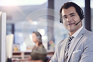 Portrait, man and smile as employee at call center with customer or client support and service. Office, crm and advisor