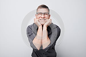 Portrait man smiling joyfully touching happy shocked face isolated on white studio background