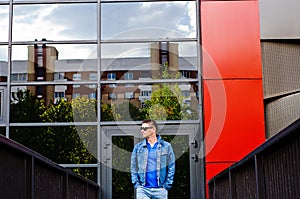 Portrait of a man in a sports suit, a jean jacket, a decorative T-shirt and jeans, a walk around the park and a commercial center photo