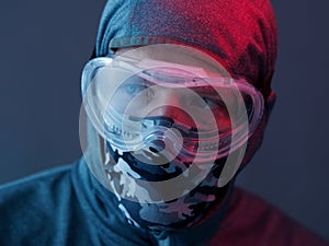 Portrait of a Man in street protest. Blue and red light.