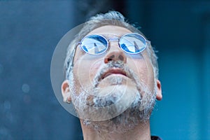 portrait of a man with sunglasses looking up