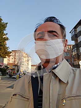 Portrait of man in a surgical bandage on a background of an empty street