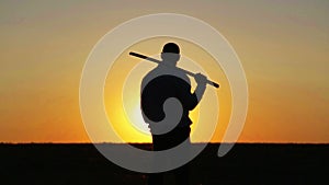 Portrait of a man with a sword at sunset, the path of a warrior. Samurai yakuza with a sword at sunset of the day.