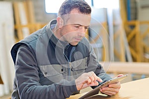 portrait man with tablet in factory warehouse