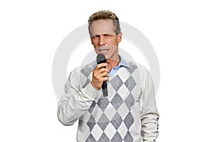 Portrait of man talking into microphone.