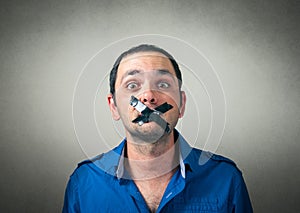 Portrait of man with taped mouth