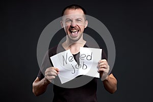 Portrait of a man tearing up an inscription on paper need a job