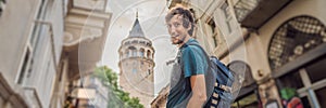 Portrait of man tourist with view of Galata tower in Beyoglu, Istanbul, Turkey. Turkiye BANNER, LONG FORMAT