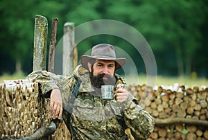 Portrait of man traveler with backpack hiking outdoor. Travel lifestyle countryside and adventure concept. Man drinking