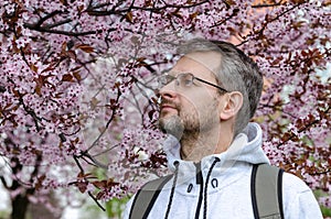 Portrait of a man under a cherry tree