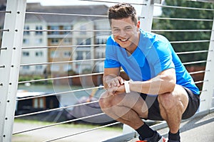 Portrait Of Man Using Activity Tracker Whilst Exercising In Ci