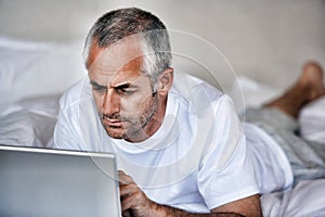 Portrait of Man Using Laptop in bed