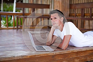 Portrait of man using tablet computer on exotic