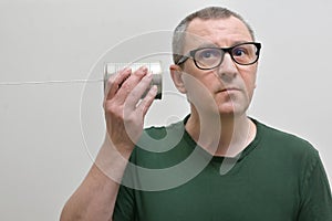 Portrait Of A Man Using A Tin Can Phone