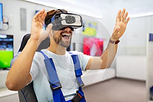Portrait of man using virtual reality headset at exhibition show. VR technology simulation concept