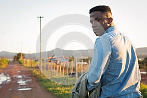 Man walking on dirt track at countryside