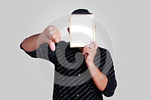 Young Asian Man Covering His Face With Small Whiteboard