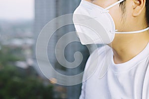 Portrait of man wearing facial hygienic mask nose outdoors.