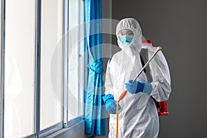 Portrait of man wearing PPE  hold a spay to prevent diffusion coronavirus protective suit, Covid-19 nCov2019 spread prevention photo