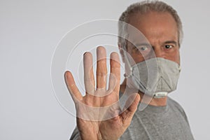 Portrait of a man wearing a protective face mask to prevent spread of viruses and other  infections. Concept of social distancing
