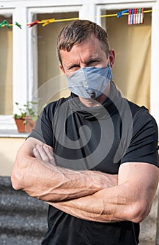 Portrait of man wearing protective mask outdoors to prevent coronavirus, covid-19, germs, toxic fumes and dust