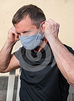 Portrait of man wearing protective mask outdoors to prevent coronavirus, covid-19, germs, toxic fumes and dust