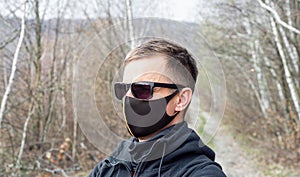 Portrait of man wearing protective mask outdoors to prevent coronavirus, covid-19, germs, toxic fumes and dust