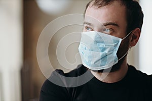 Portrait of man wearing a protective medical face mask to prevent infection of coronavirus.