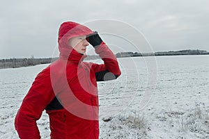 Portrait of man wearing protective winter running jacket during his training session