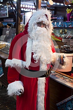 portrait of man wearing a santa claus costume at the mulled wine cabin at the christmas