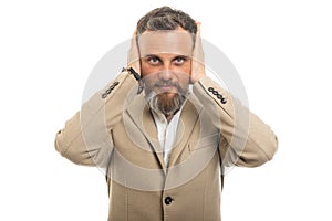 Portrait of man wearing smart casual covering ears