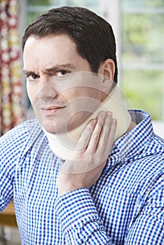 Portrait Of Man Wearing Surgical Collar In Pain