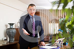Portrait of man welcoming to company office
