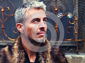 Portrait of a man in wolf fur and ornamental medieval windowPortrait of a man in wolf fur and ornamental medieval wind