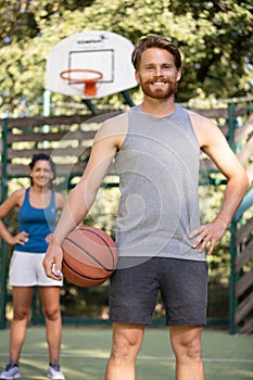 portrait man and woman on basketball court