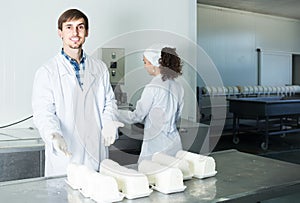 Portrait of man and woman dressed in lab coats are looking happy