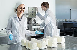 Portrait of man and woman dressed in lab coats are looking happy