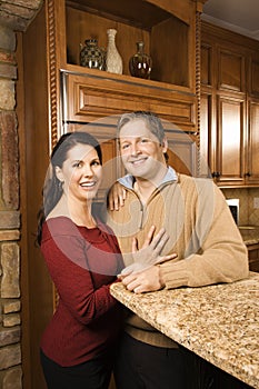 Portrait of man and woman in kitchen.