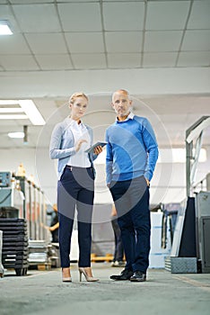 Portrait, man and woman with tablet in factory for production monitoring, inventory or order management and inspection