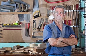 Portrait of man at work in workshop in garage at home