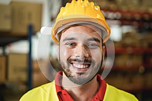 Portrait of man worker smiling on camera inside warehouse - Focus on mouth