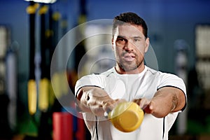 Portrait, man and workout with kettlebell in gym for fitness, wellness or healthy body. Face, person and strong