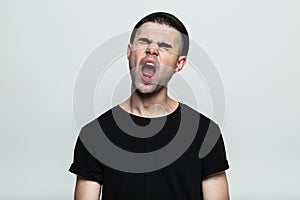 Portrait of man yawning.