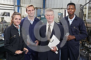 Portrait Of Manager And Staff In Engineering Factory