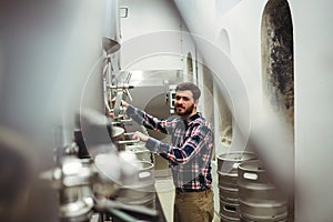 Portrait of manufacturer inspecting machineries