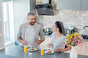 portrait of married couple having breakfast together photo