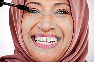Portrait, mascara brush and woman in hijab for facial beauty, skincare and cosmetics in studio with smile. Face of happy photo